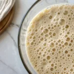 Close-up of a frothy beverage in a glass.